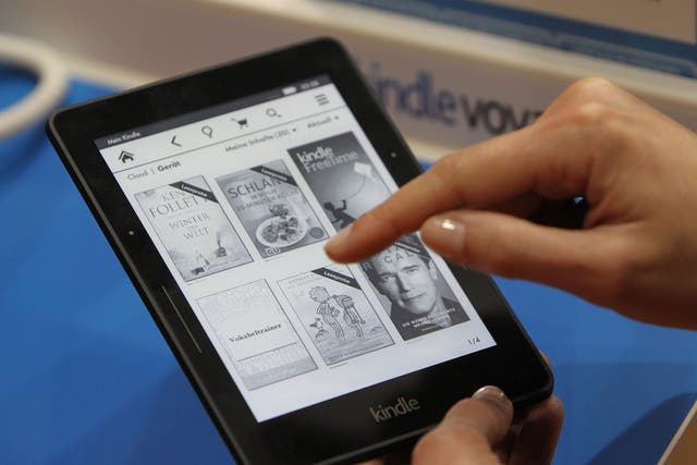 A woman uses the Amazon Kindle at a book fair