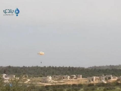A pilot parachutes from a plane that was shot down in this still image taken from video footage