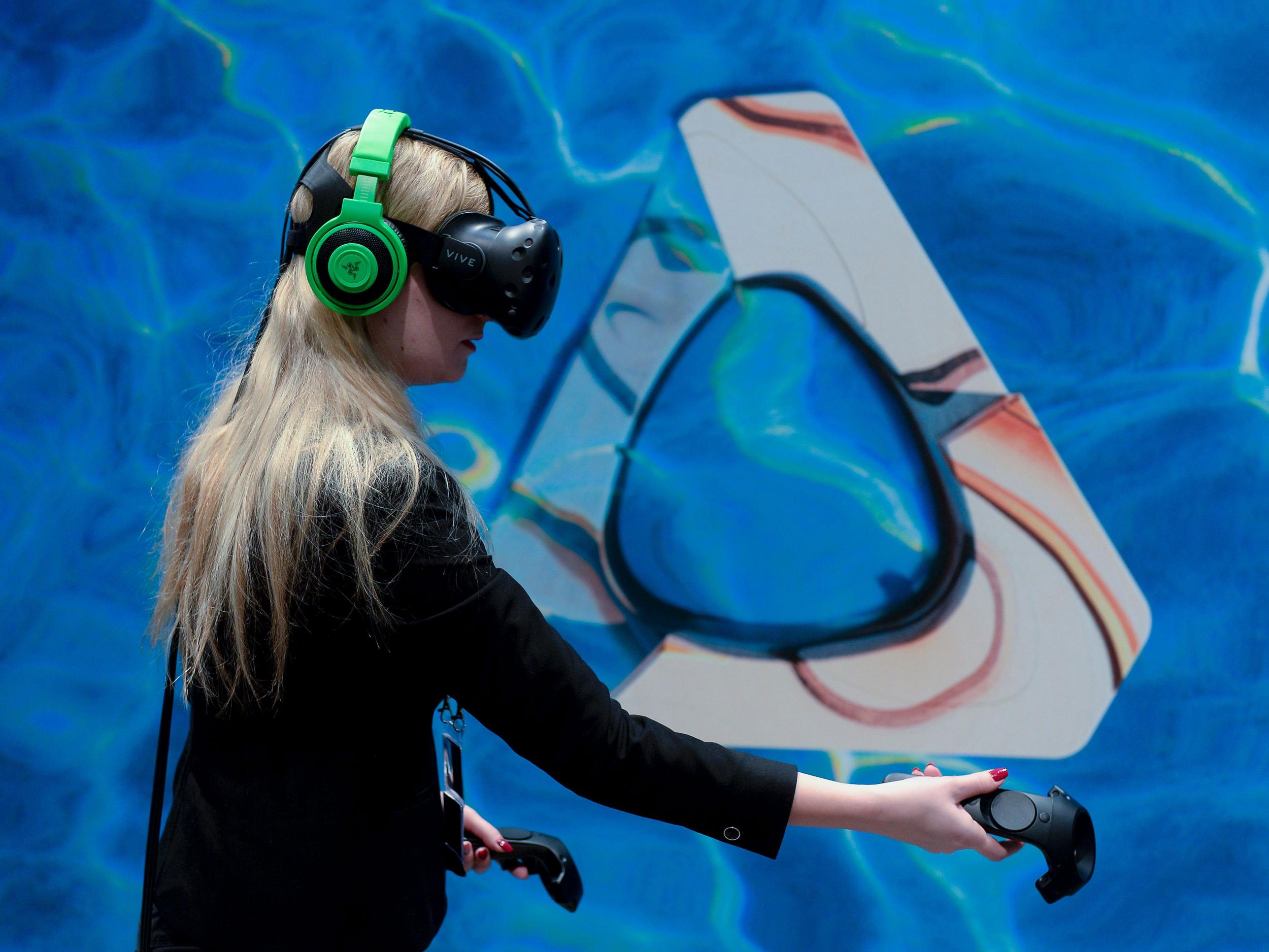 A woman uses the HTC Vive at Mobile World Congress in February 2016