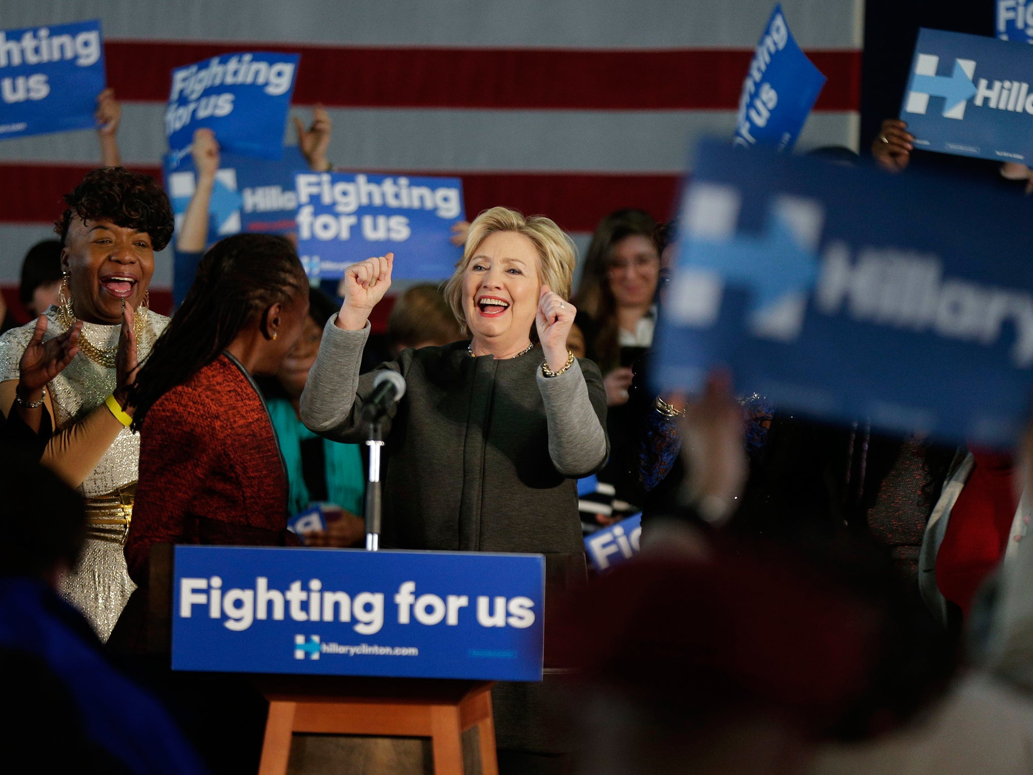 Hillary Clinton steps to the podium as she is introduced to an room of excited supporters AP