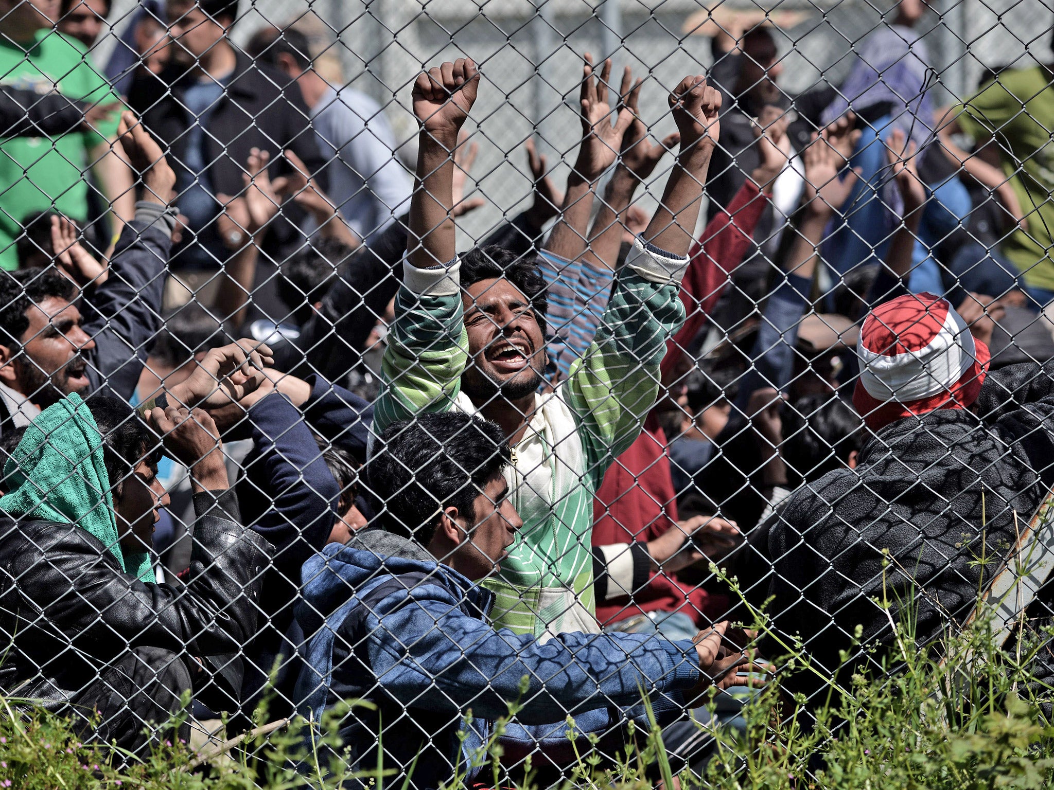 Refugees protest inside a detention center in Mytilene, Lesbos
