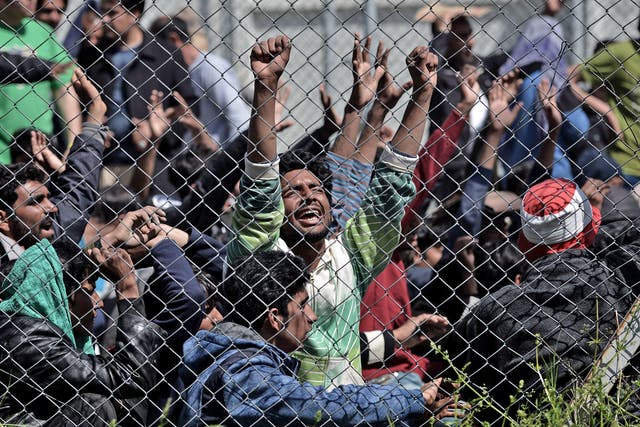 Refugees protest inside a detention center in Mytilene, Lesbos