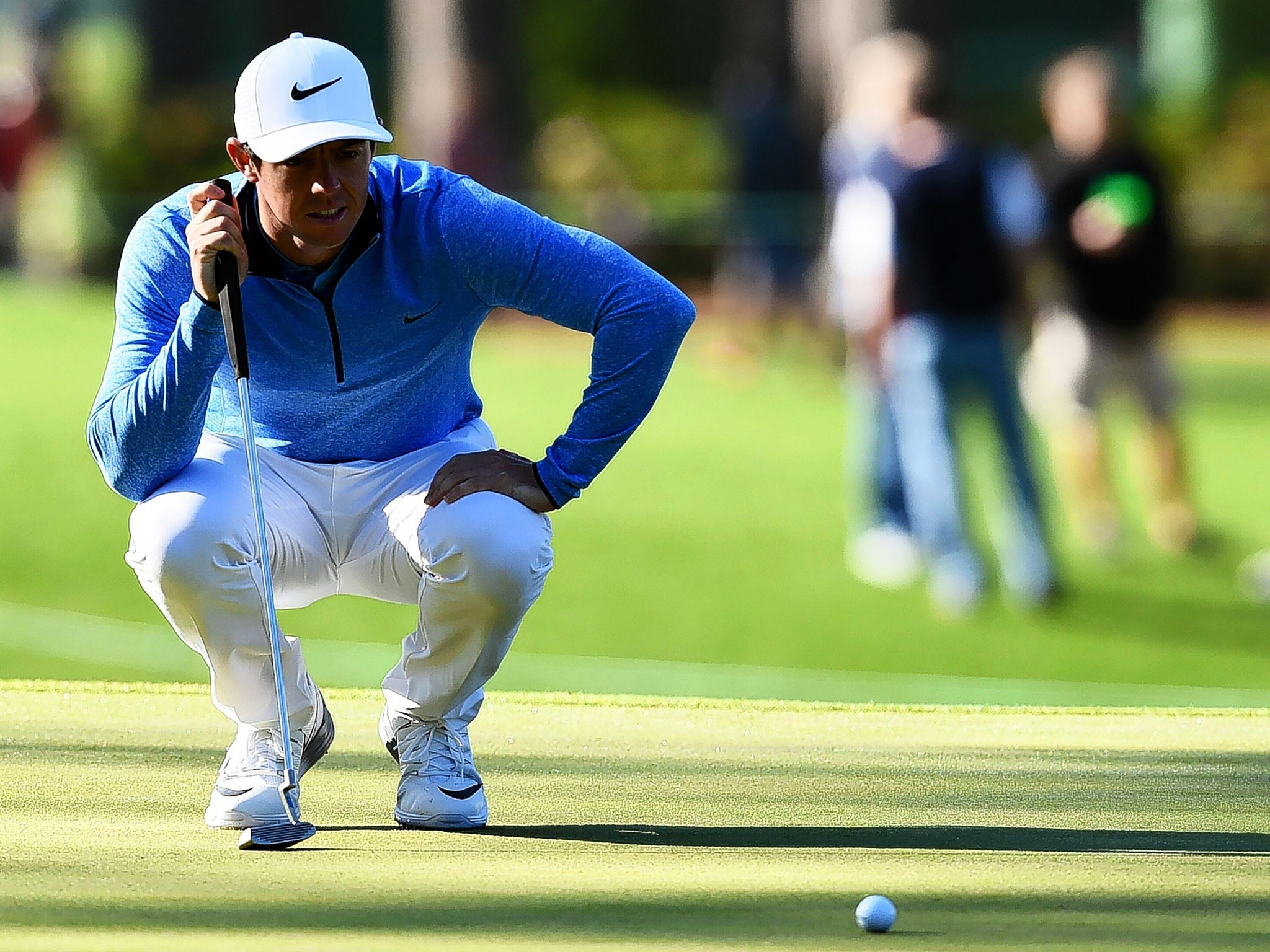 Rory McIlroy lines up a putt during a practice round in Augusta