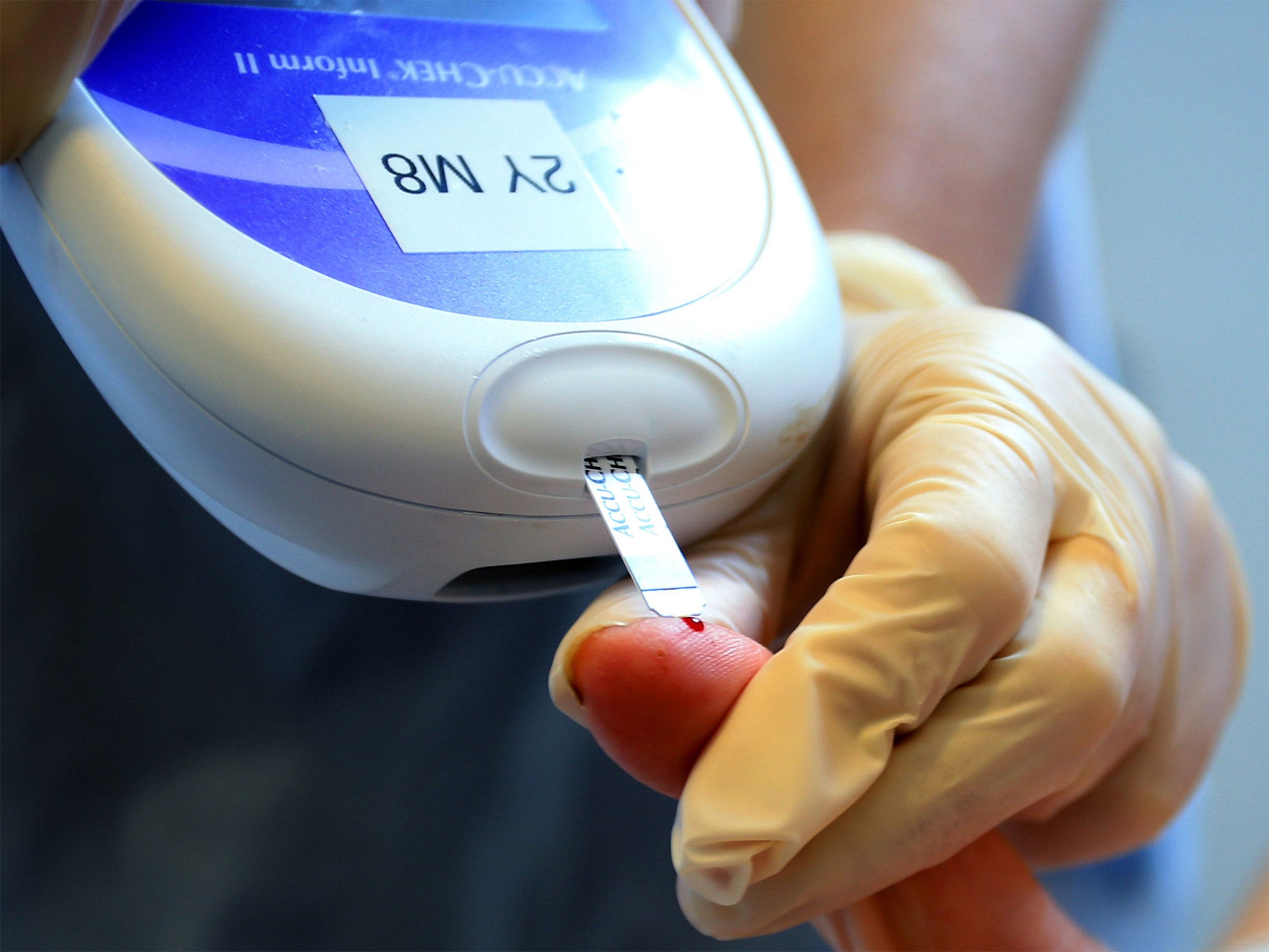A nurse gives a patient a diabetes test