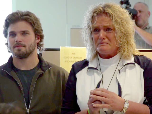 Lisa Swanson, right, and her son Shelby Schulz hear Schultz's twin brother's heart beat inside heart transplant recipient Terry Hooper, in Omaha, Nebraska