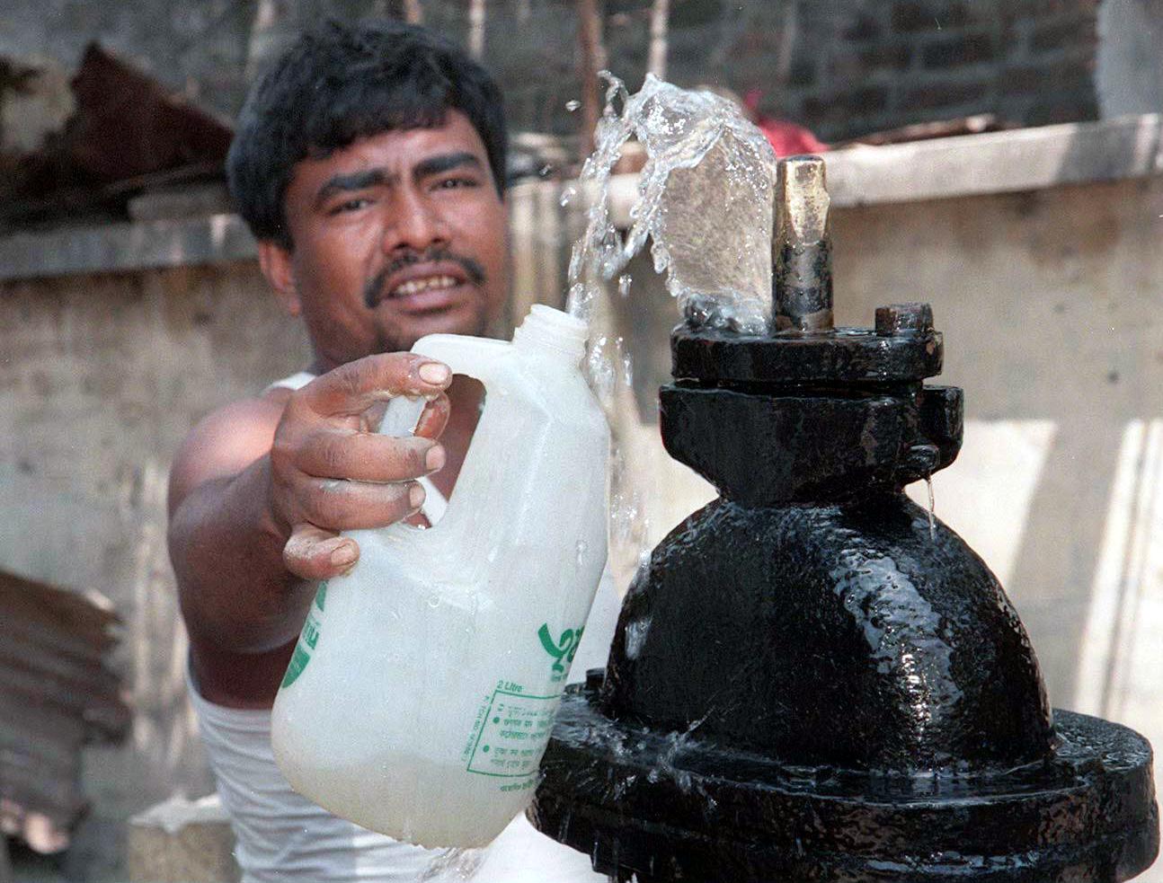 A Bangladeshi man fills a bottle at one of the nation's estimated 20,000,000 groundwater pumps