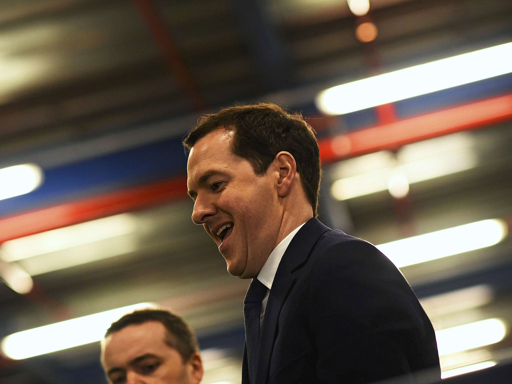 George Osborne checks food items during a visit to the Ocado Customer Fulfilment Centre in Hatfield, 6 April 2016