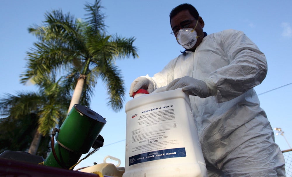 A health worker prepares insecticide in San Juan.