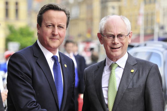 Former European Council President Herman Van Rompuy shakes hands with British Prime Minister David Cameron
