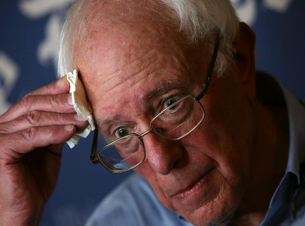 DES MOINES, IA - AUGUST 15: Democratic presidential candidate U.S. Sen. Bernie Sanders (I-VT) wipes sweat from his forehead during an interview at Iowa State Fair on August 15, 2015 in Des Moines, Iowa