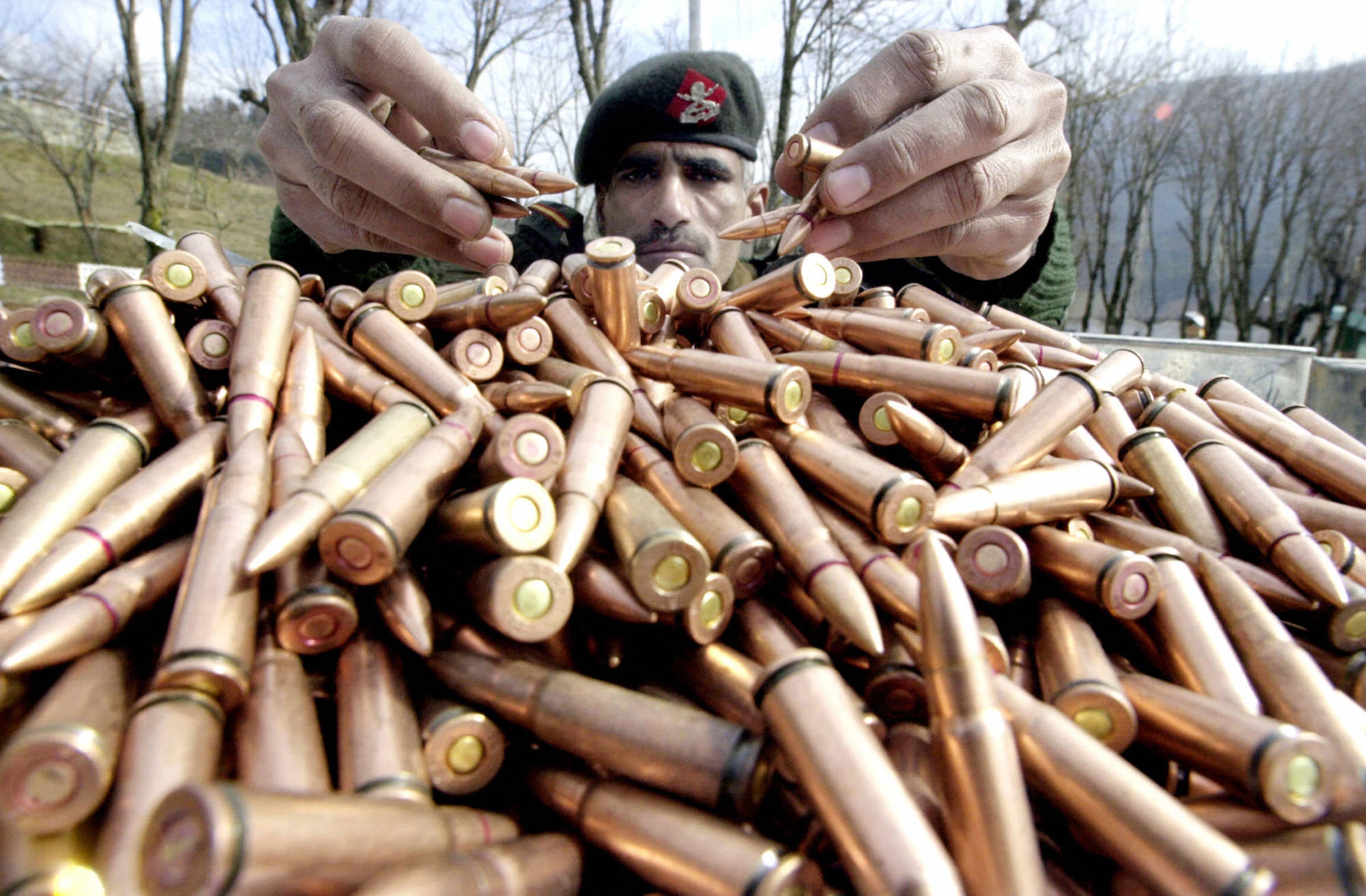 An Indian army soldier displays bullets seized from rebels