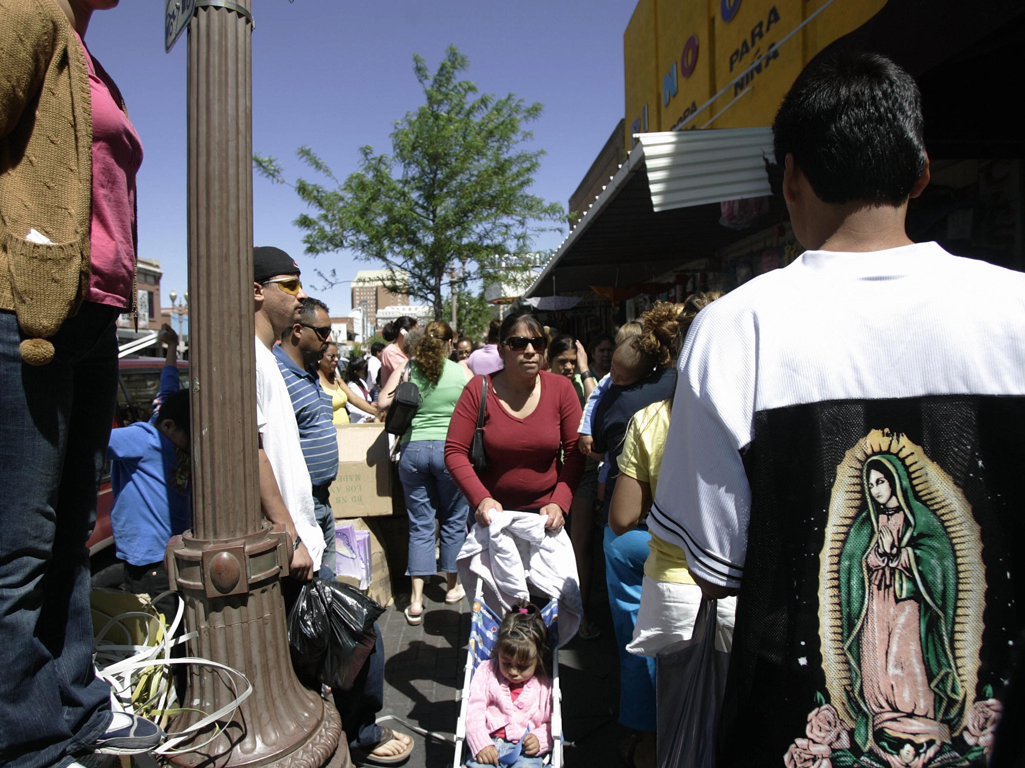 El Paso residents walk through a local market Hector Mata / Getty Images