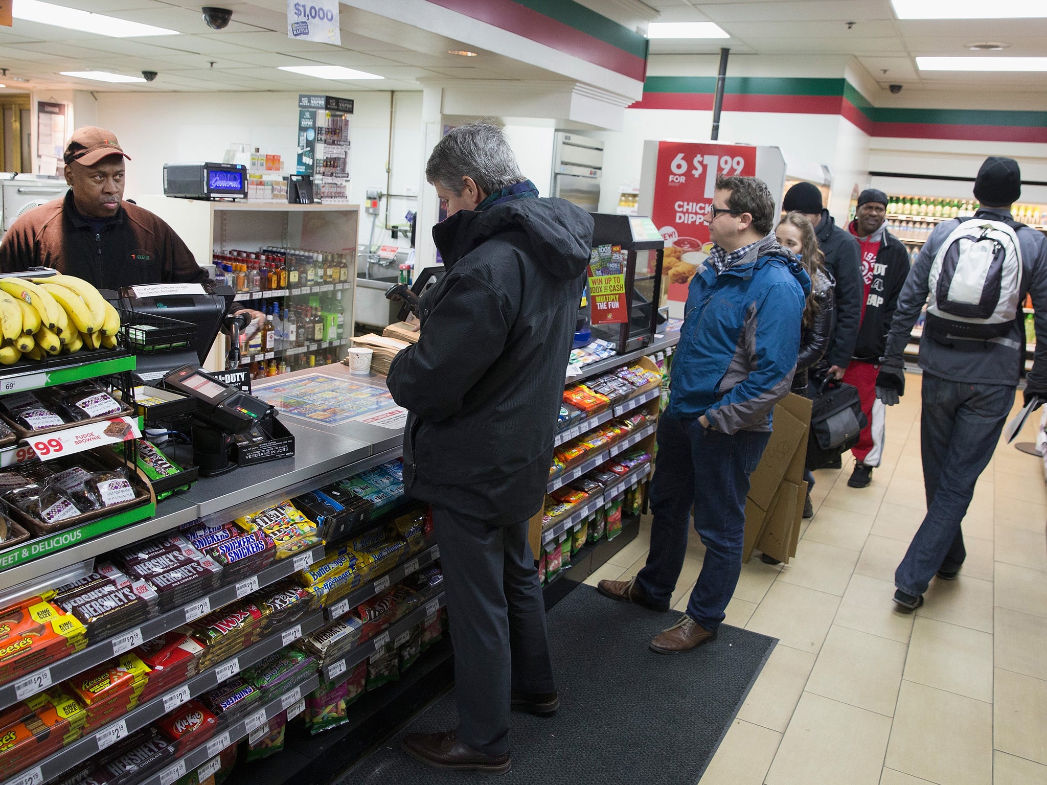 Customers await their transactions at a 7-Eleven store Scott Olson / Getty Images