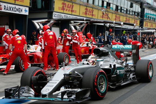 Lewis Hamilton drives past the Ferrari garage during qualifying at the Australian Grand Prix
