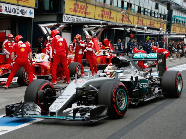 Lewis Hamilton drives past the Ferrari garage during qualifying at the Australian Grand Prix