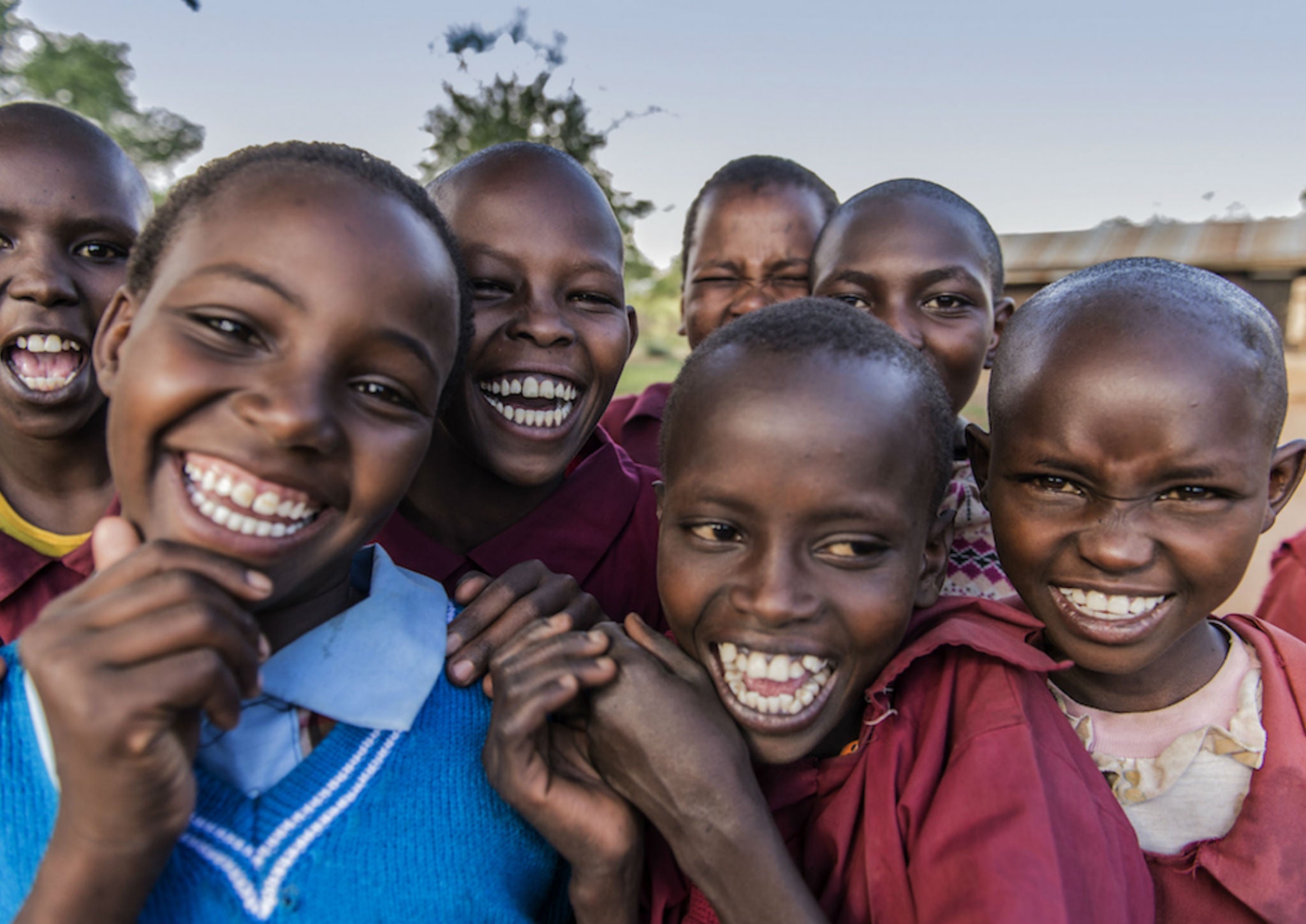 Kenyan children smile for a photo at Ewaso Primary School, that benefits from the conservancy (Ami Vitale for The Nature Conservancy)