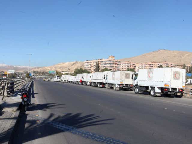 A convoy of trucks laden with with relief head out from Damascus, bound for the rebel-held towns of Madaya and Zabadani, in February. The UN says getting aid into besieged towns has proved difficult
