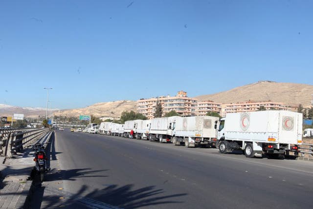 A convoy of trucks laden with with relief head out from Damascus, bound for the rebel-held towns of Madaya and Zabadani, in February. The UN says getting aid into besieged towns has proved difficult
