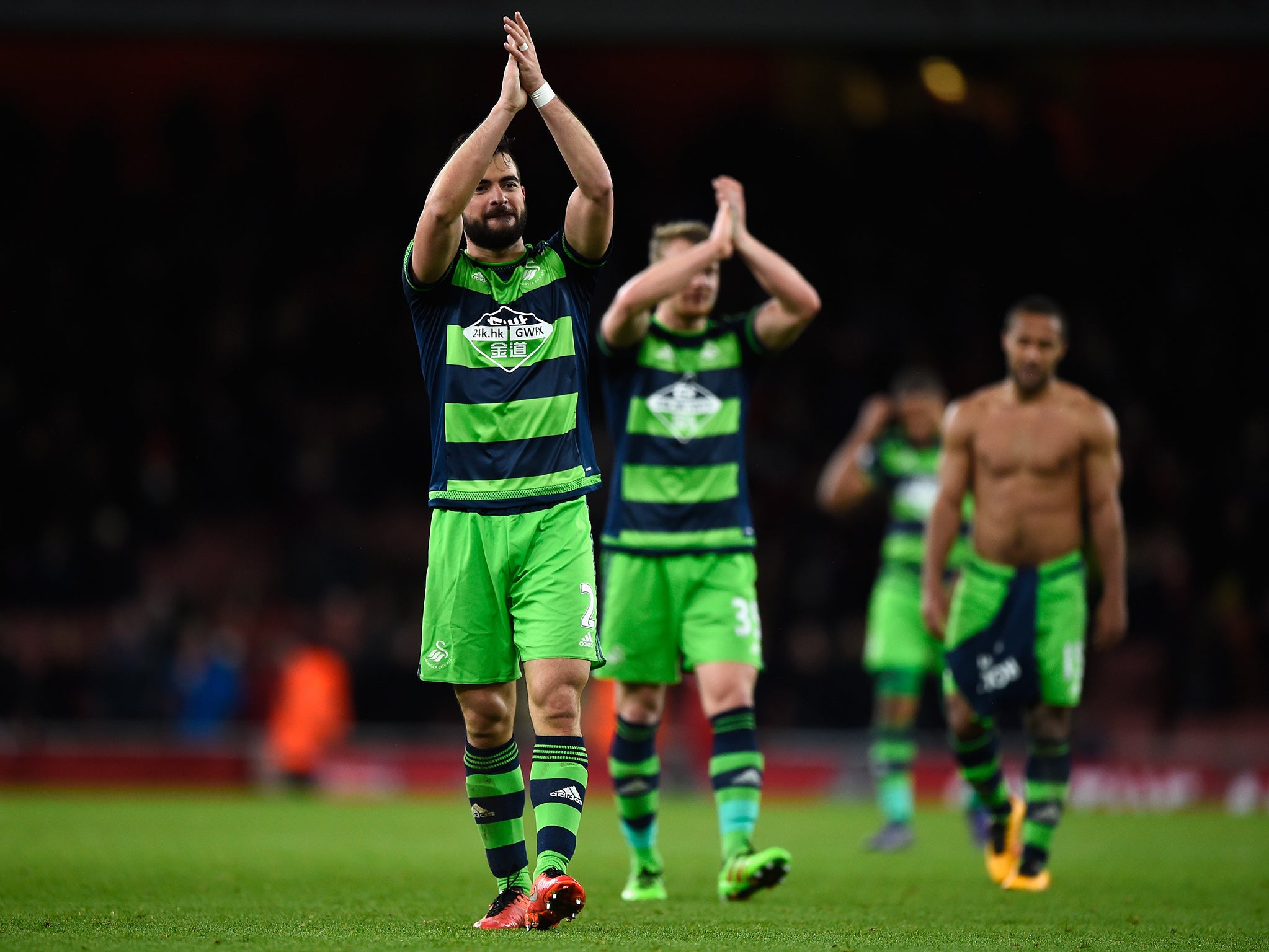 Jordi Amat applauds the away support after Swansea's win over Arsenal