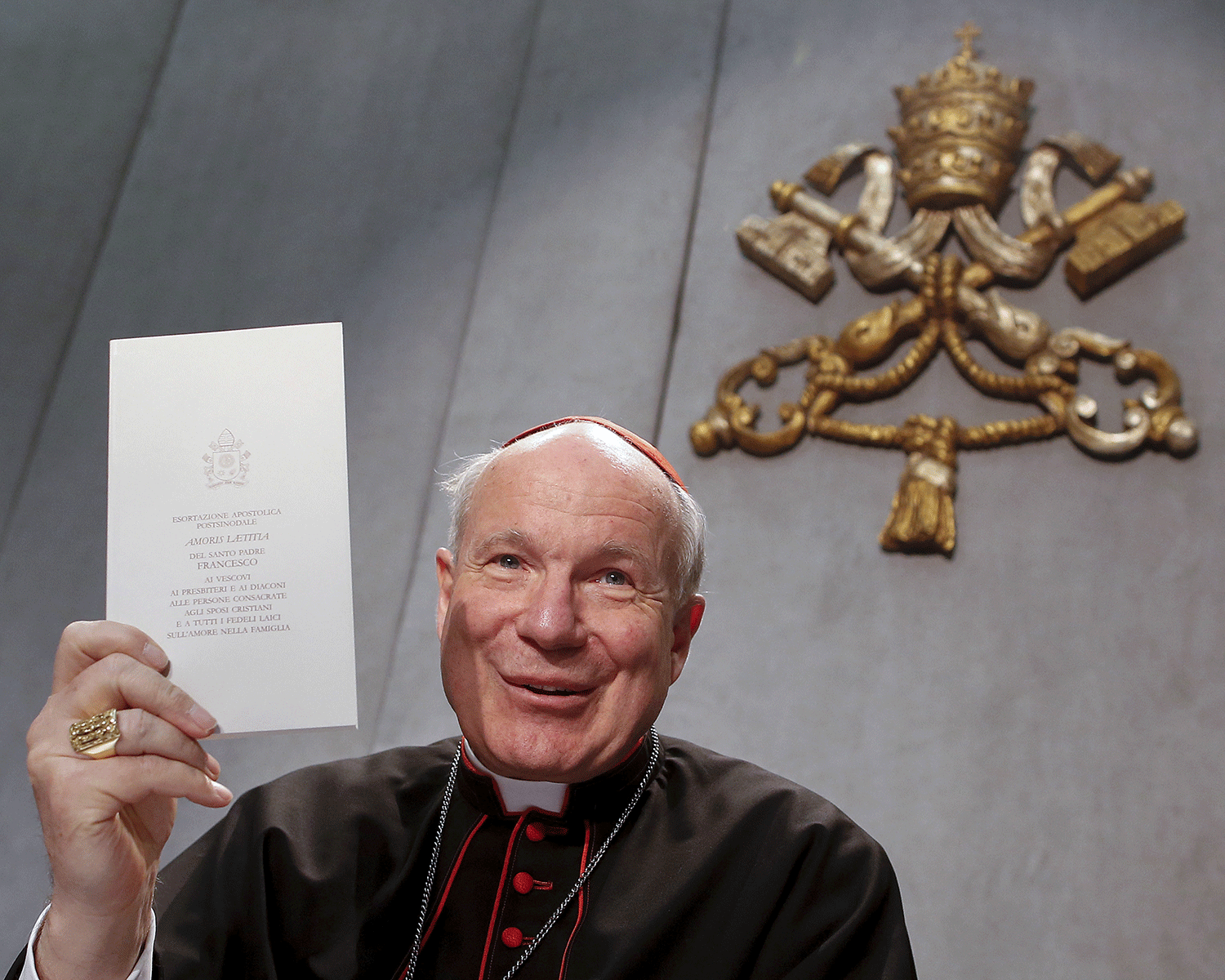 Austrian Cardinal Christoph Schoenborn shows the document Amoris Laetitia by Pope Francis during a news conference at the Vatican April 8, 2016