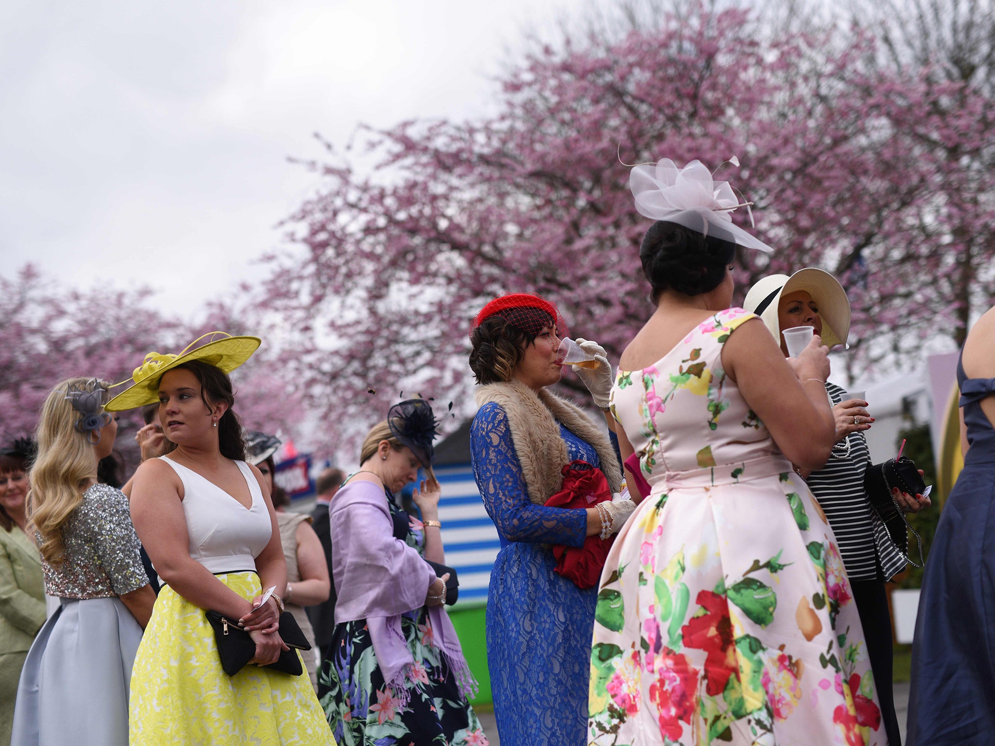Racegoers attend Ladies Day, the second day of the Grand National Festival horse race meeting, at Aintree Racecourse in Liverpool