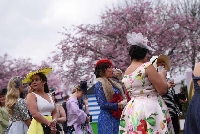 Racegoers attend Ladies Day, the second day of the Grand National Festival horse race meeting, at Aintree Racecourse in Liverpool