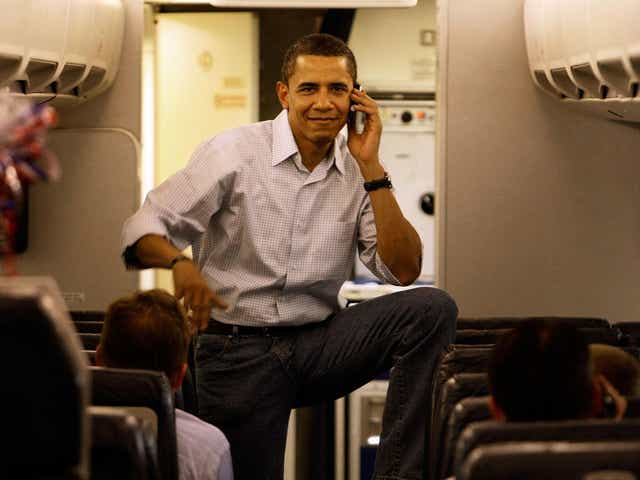 Then Democratic presidential hopeful Barack Obama talks on his cell phone as he boards his campaign plane at Midway Airport en-route to Washington DC, May 7, 2008