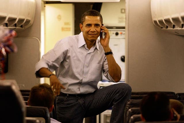 Then Democratic presidential hopeful Barack Obama talks on his cell phone as he boards his campaign plane at Midway Airport en-route to Washington DC, May 7, 2008
