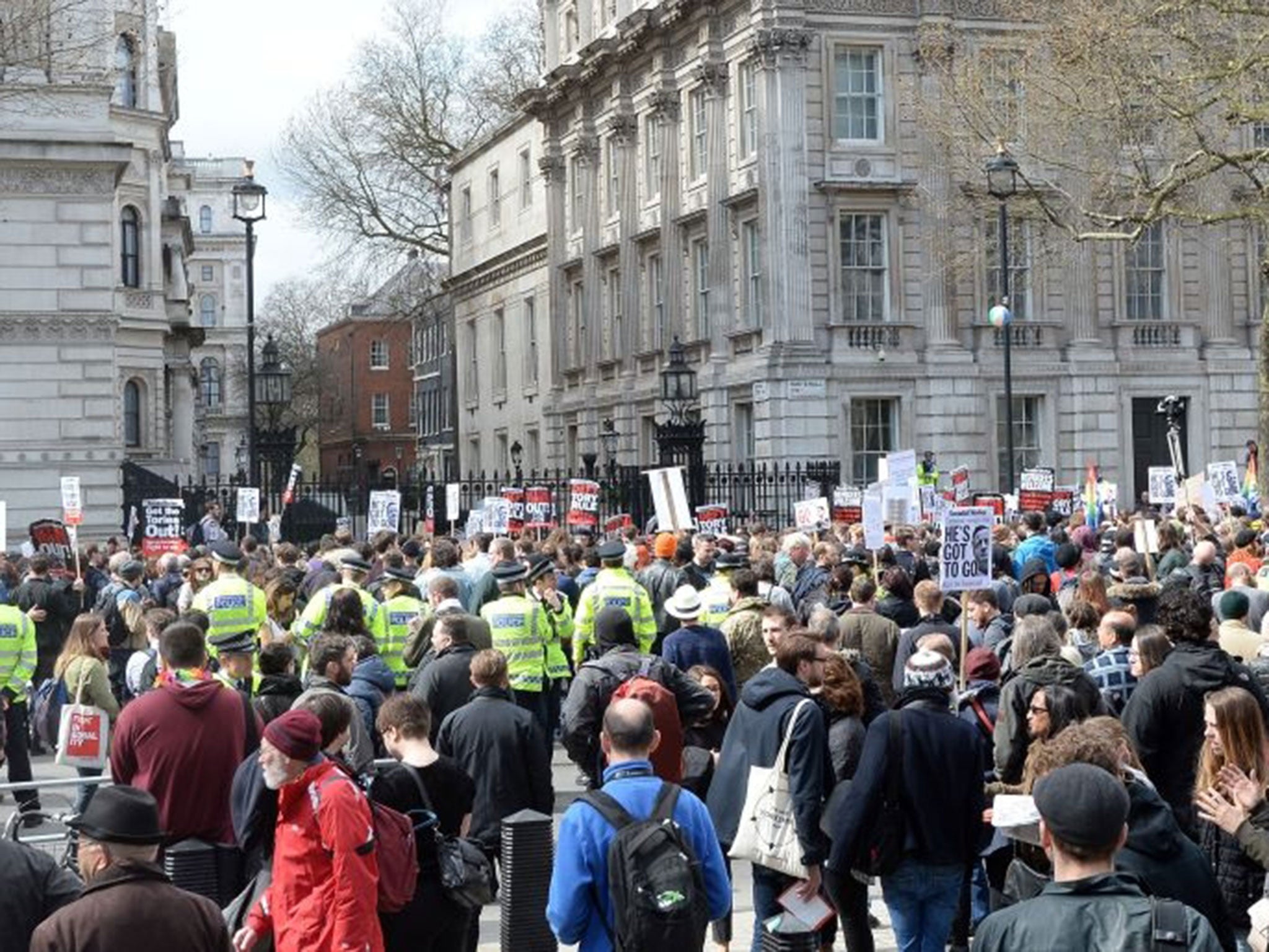 Protesters gather outside the gates of Downing Street before moving towards the venue of the Tory Spring Conference