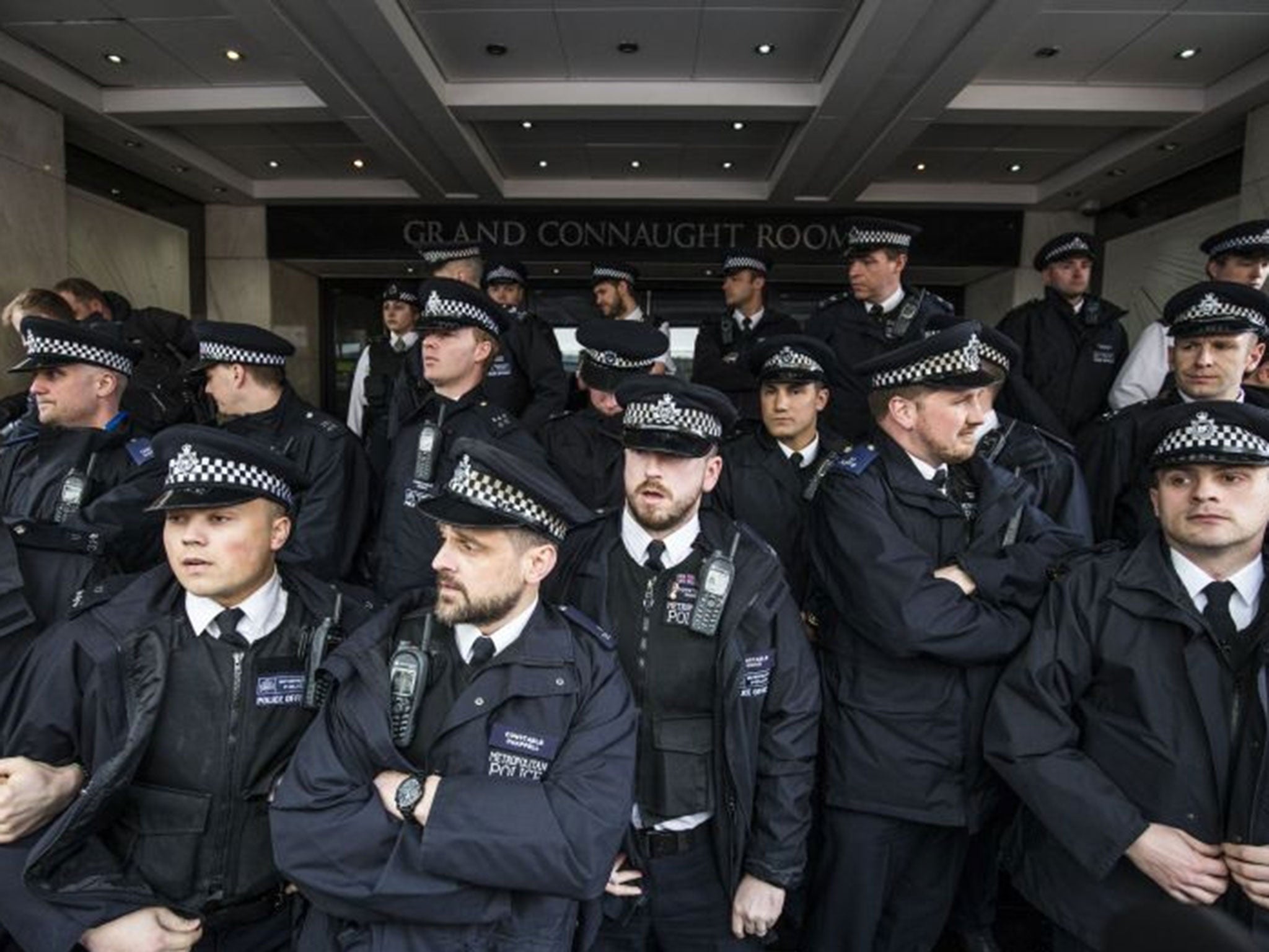 Police form a cordon around the Grand Connaught Rooms where the Tory Spring Conference is being held today as protesters gather for the 'David Cameron: close tax loopholes or resign!' demonstration