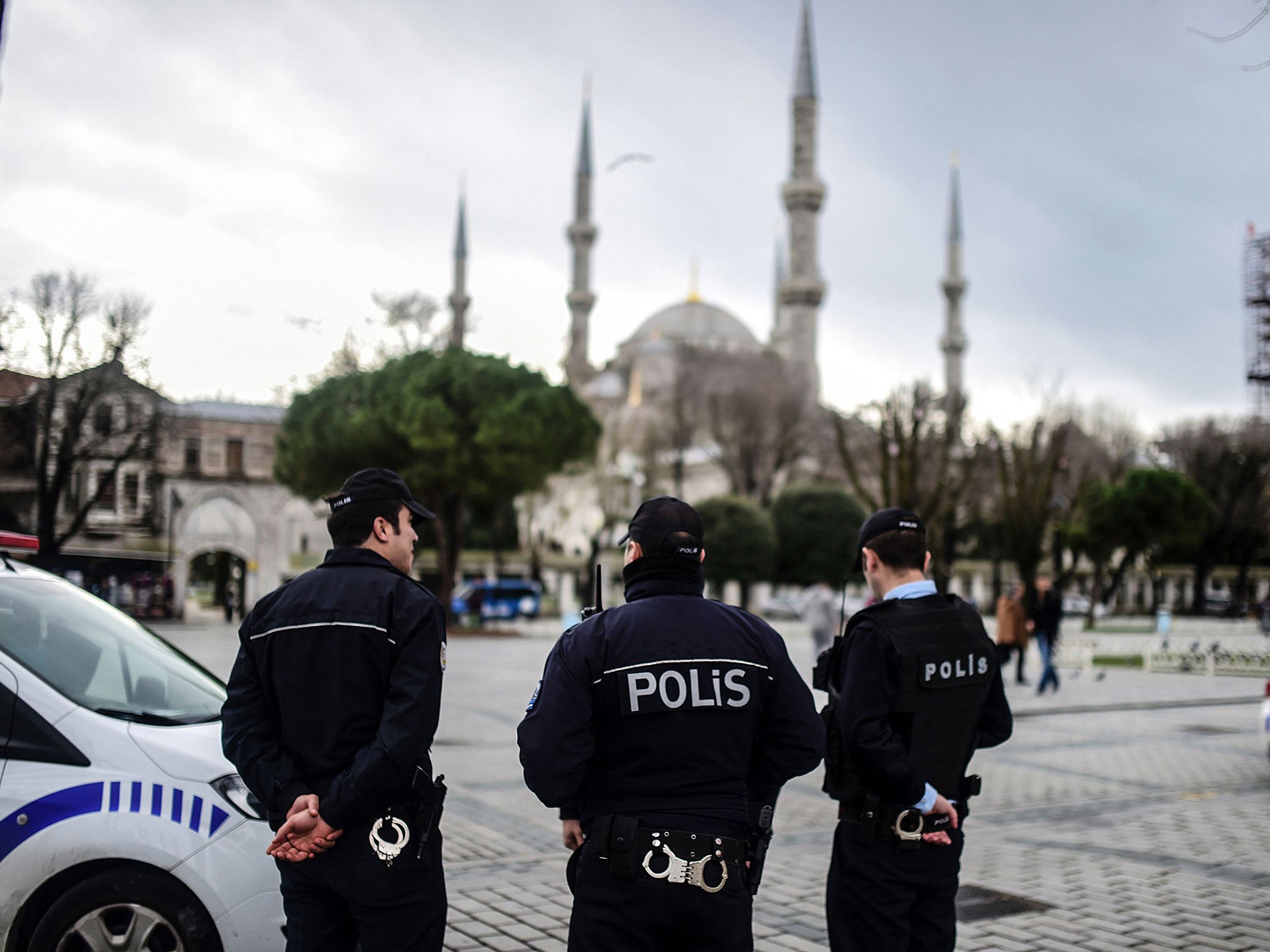 Turkish police officers stand guard near the Blue Mosque in Istanbul's tourist hub of Sultanahmet