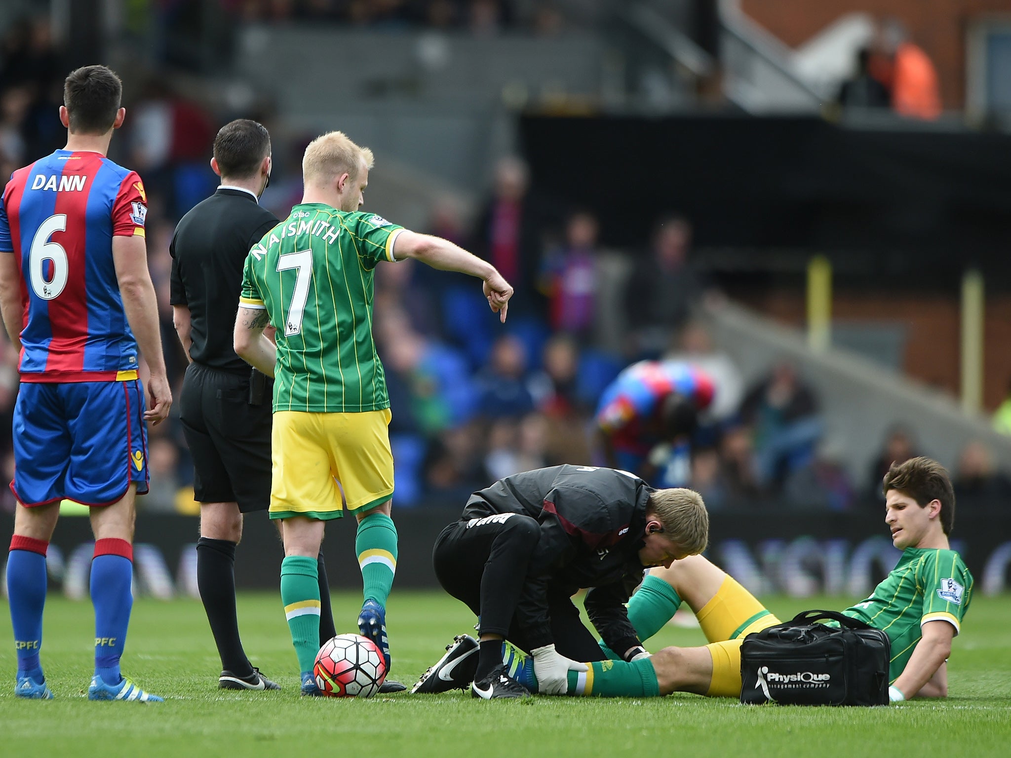 Timm Klose receives treatment before leaving the field injured