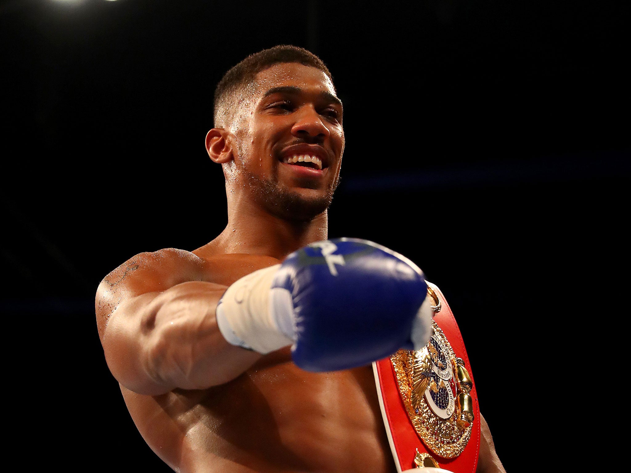 Anthony Joshua celebrates winning the IBF title