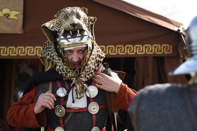A man prepares for an Imperial Roman Army battle re-enactment at Hadrian's Wall in September 2015