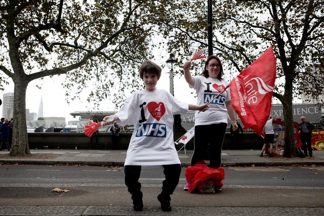 A young boy wears a t-shirt which reads 'I Love The NHS' during a march organised by the Trades Union Congress on October 18, 2014 in London, England.