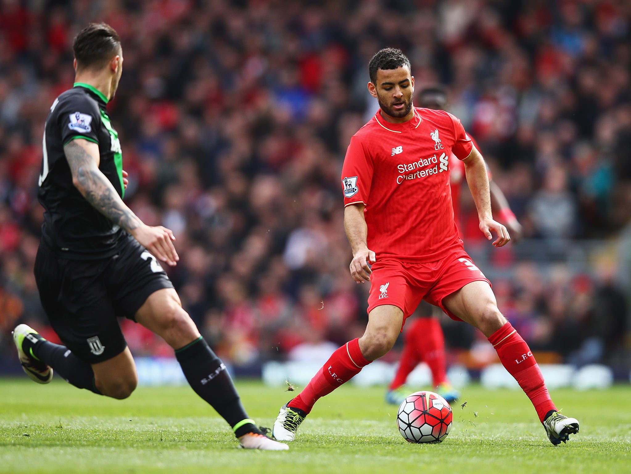 Liverpool midfielder Kevin Stewart plays a pass