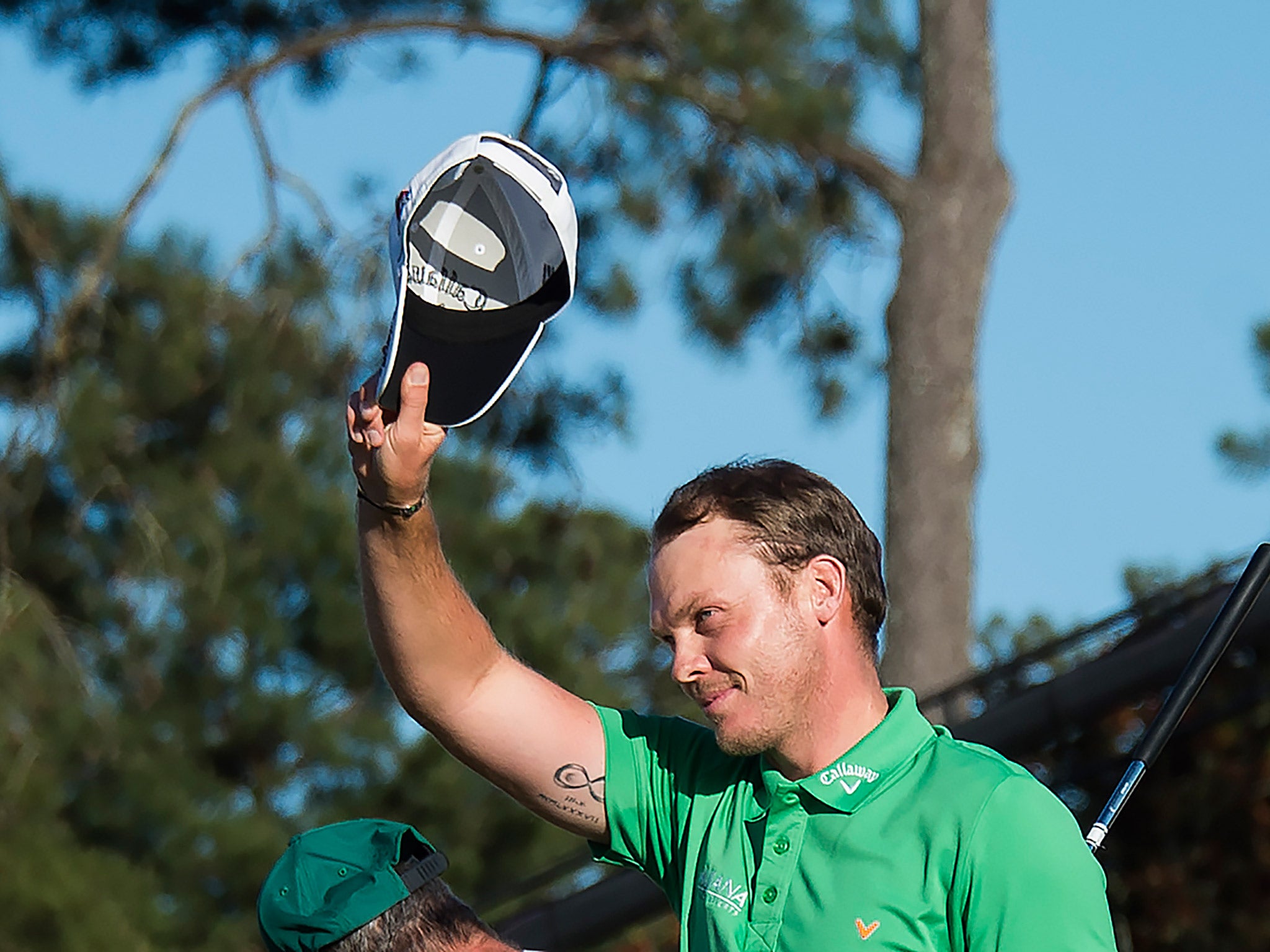 Danny Willett raises his cap after winning The Masters Championship