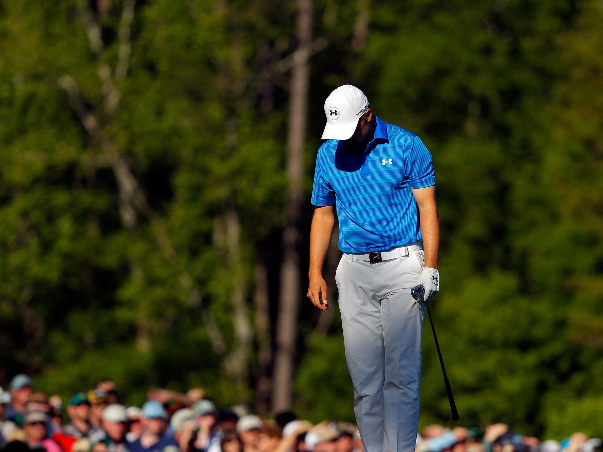 Jordan Spieth reacts after hitting into the water for the second time on the 12th hole