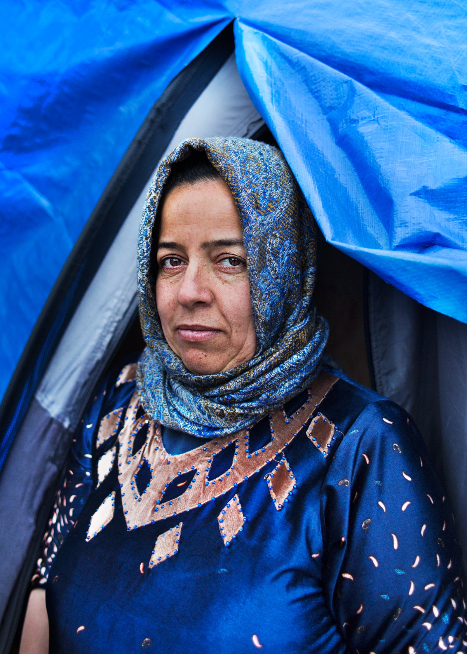 An Iraqi mother of two stands outside her MSF shelter in the newly built Dunkirk camp (Photo: Emily Garthwaite)