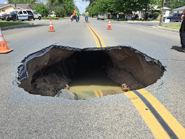 Video shows huge sinkhole open up on street in California