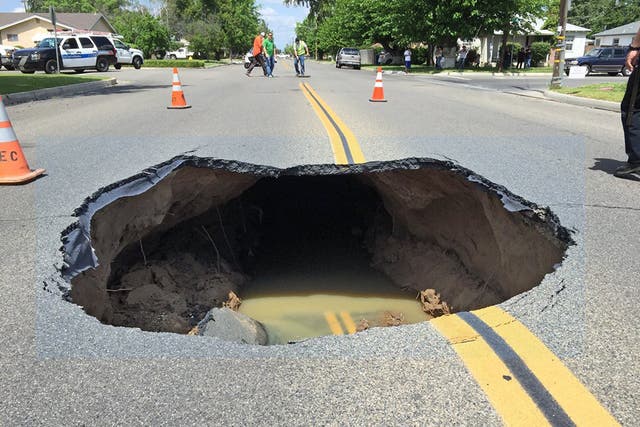 Video shows huge sinkhole open up on street in California