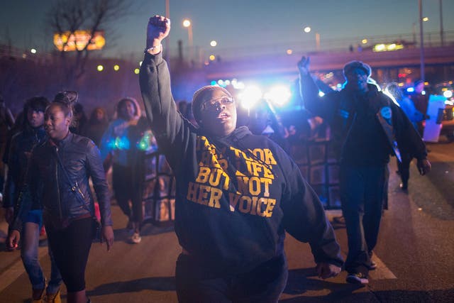 Demonstrators protesting the shooting death of 16-year-old Pierre Loury block traffic on the Eisenhower Expressway during a march