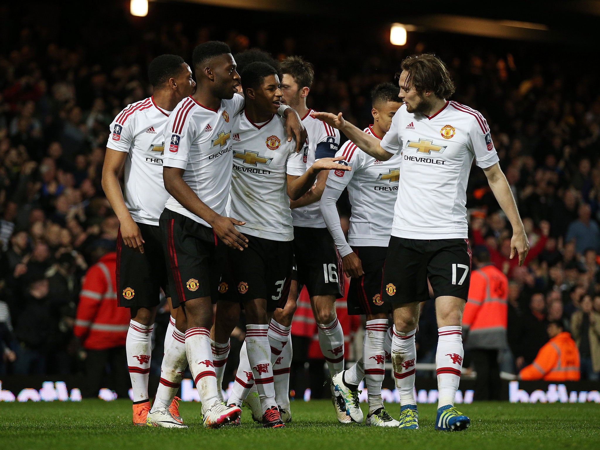 Marcus Rashford is mobbed by his team-mates after his goal