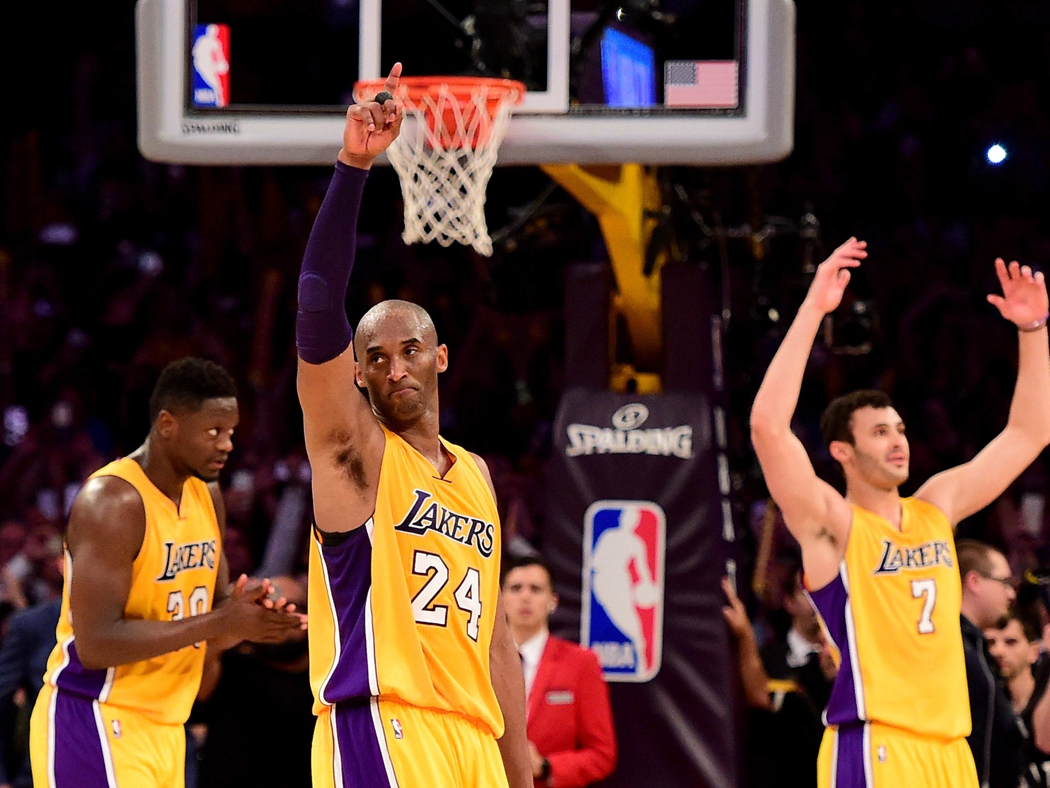 Kobe Bryant waves to the crowd after retiring from the NBA