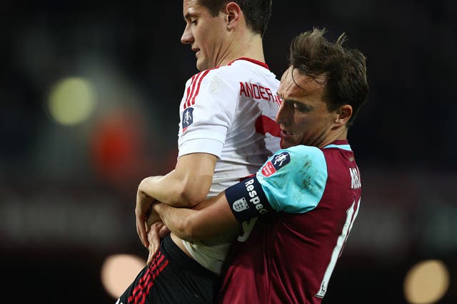 Noble carries the injured Herrera off the field