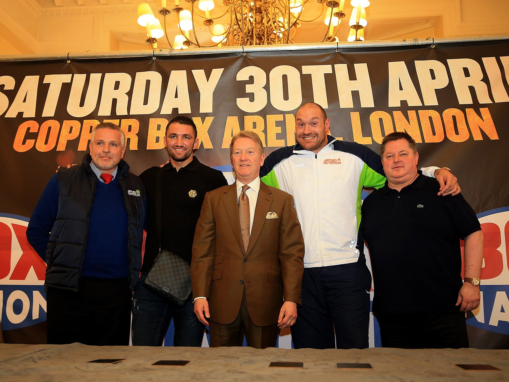 Fury's team poses for a photograph after the press conference