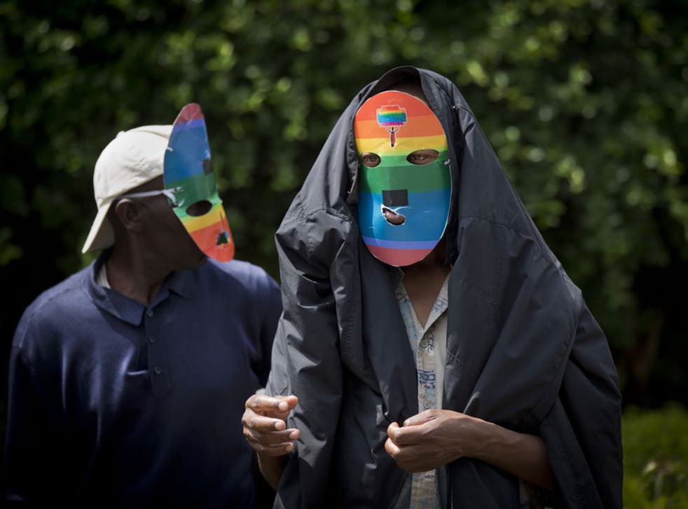 Kenyan LGBT people wear masks to protect their anonymity as they stage a rare protest against restrictions on homosexuality in 2014