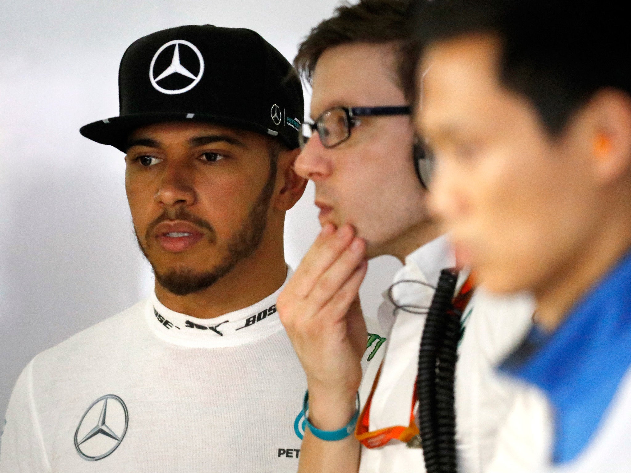 A concerned Lewis Hamilton looks on after his Mercedes suffered an engine failure during qualifying