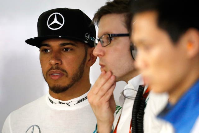 A concerned Lewis Hamilton looks on after his Mercedes suffered an engine failure during qualifying