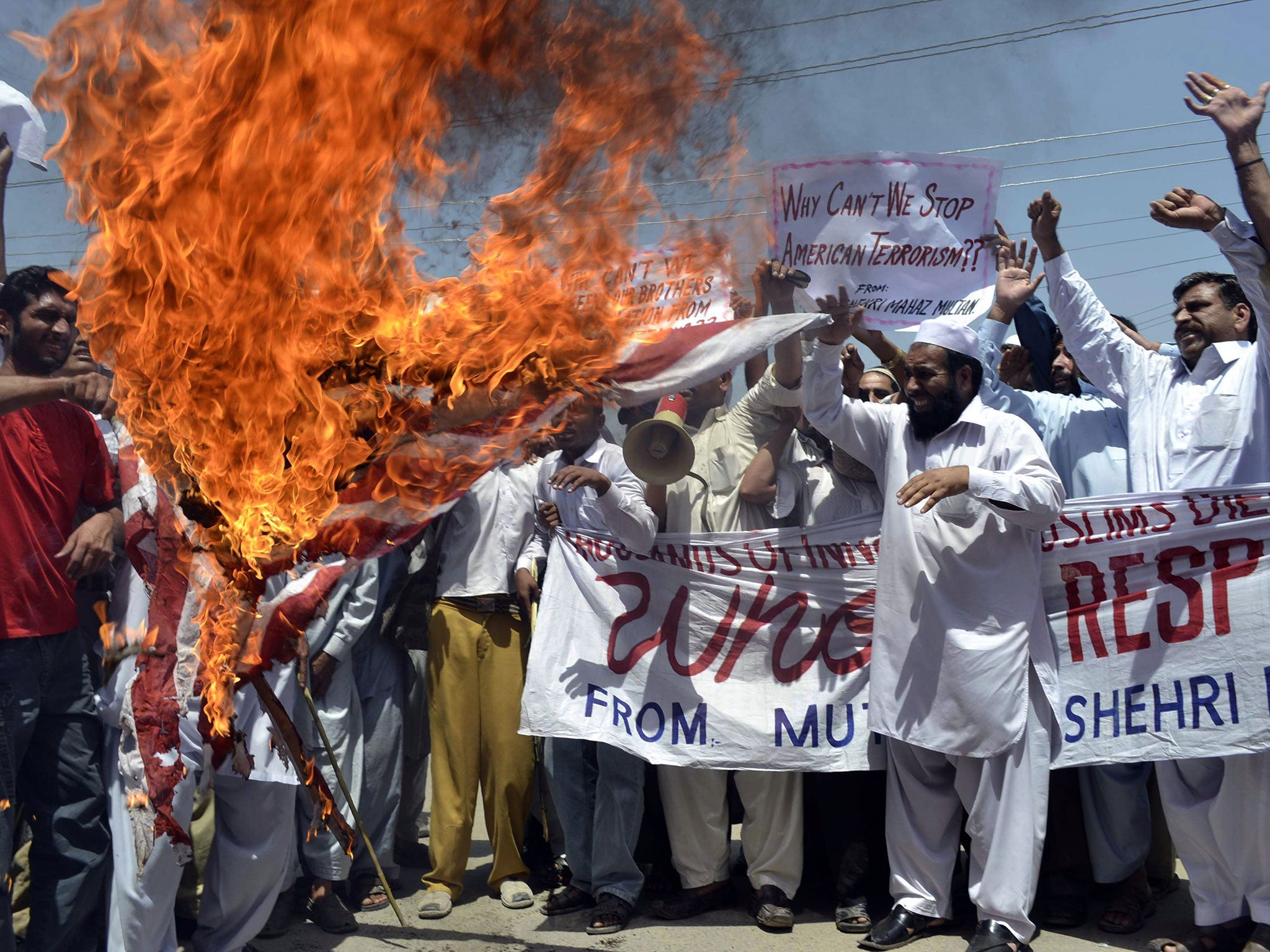 Pakistani protesters burn a US flag during a protest in Multan on April 22, 2011 against US drone attacks in Pakistani tribal areas